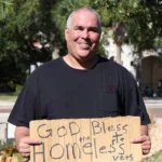 Jeff Gray holding sign that says "God Bless the Homeless Vets"